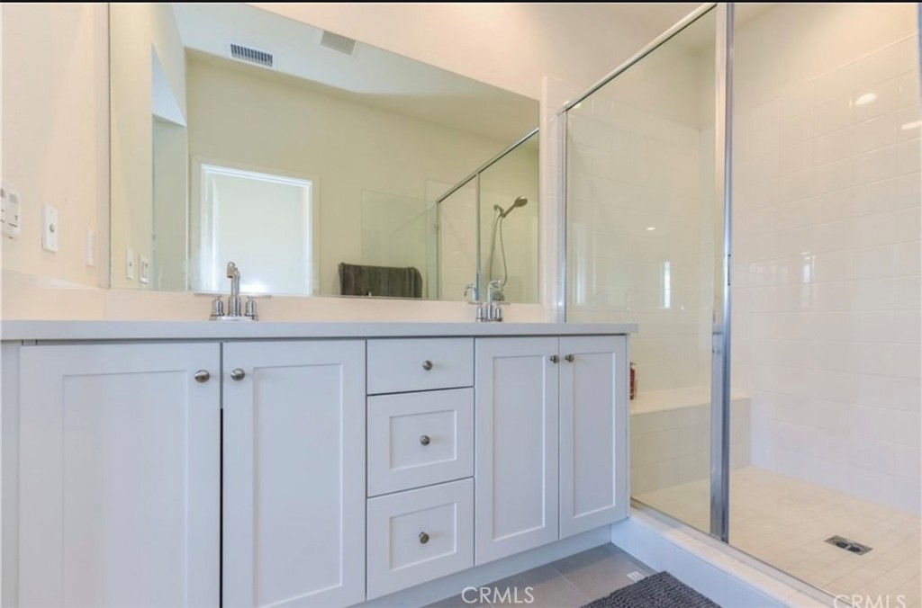175 Frame Irvine, CA 92618 - Photo 18 of 22 a bathroom with a shower sink and mirror