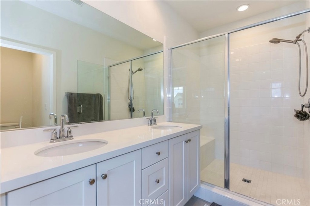 175 Frame Irvine, CA 92618 - Photo 19 of 22 a bathroom with a shower sink and mirror