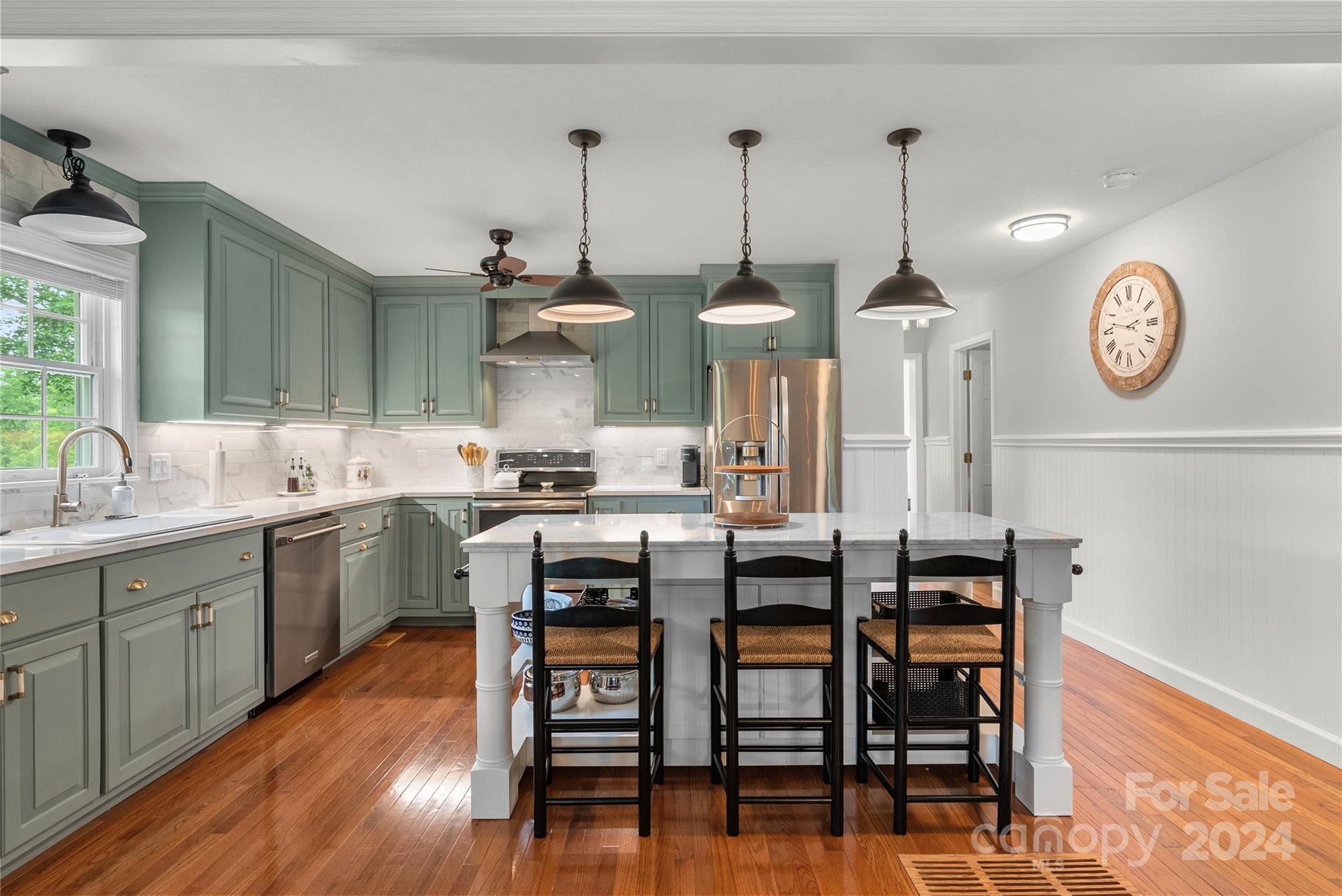 1154 Landrum Road Columbus, NC 28722 - Photo 11 of 36 a kitchen with stainless steel appliances kitchen island granite countertop a table chairs sink and cabinets