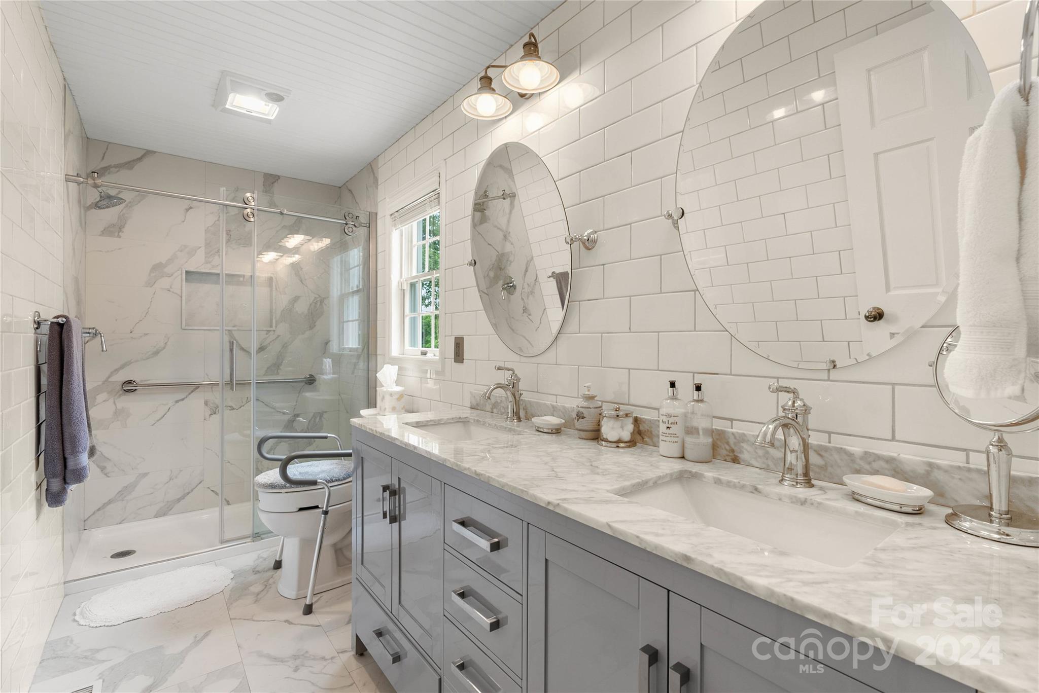 1154 Landrum Road Columbus, NC 28722 - Photo 18 of 36 a bathroom with a double vanity sink mirror and shower