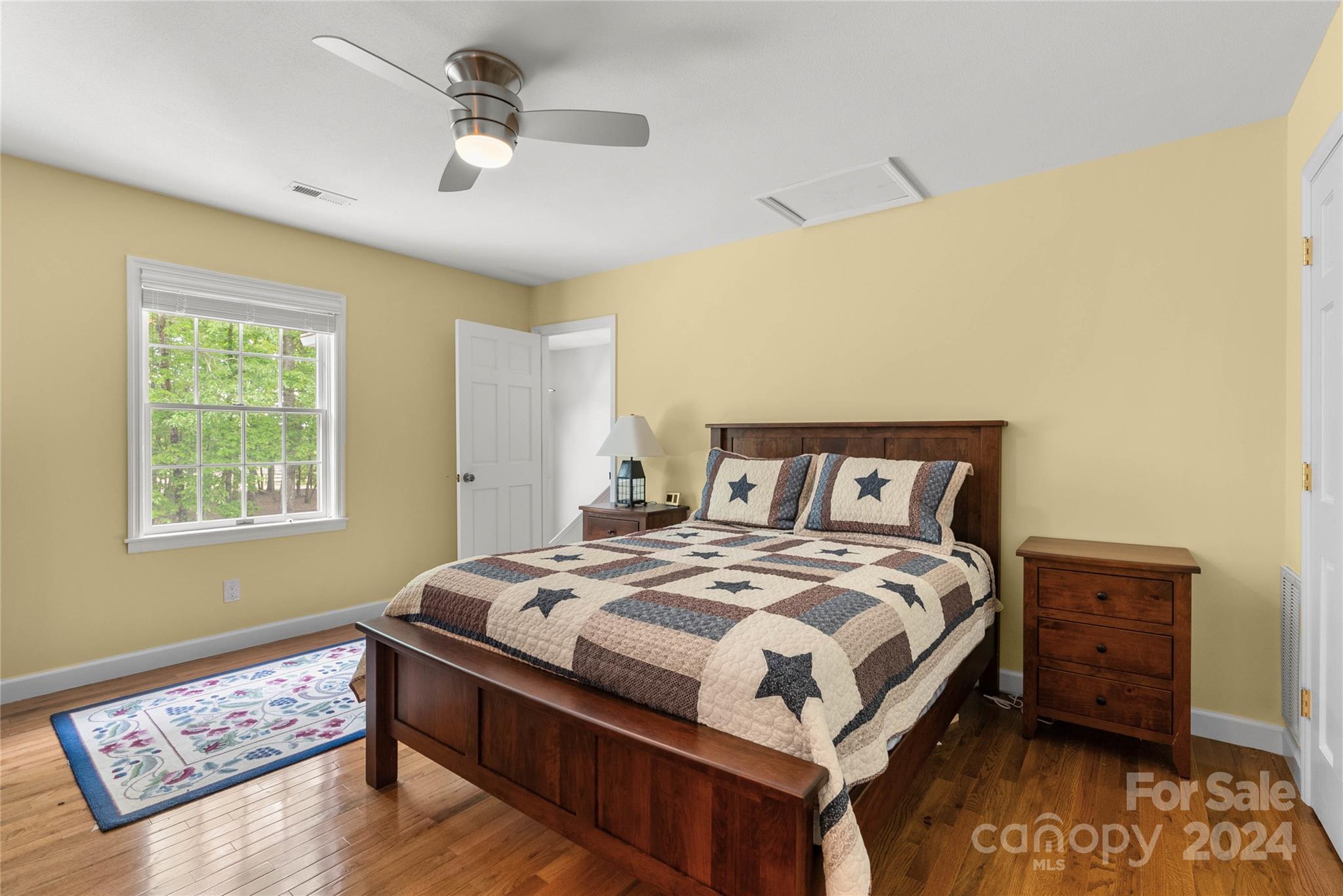 1154 Landrum Road Columbus, NC 28722 - Photo 20 of 36 a bedroom with a bed and a chandelier
