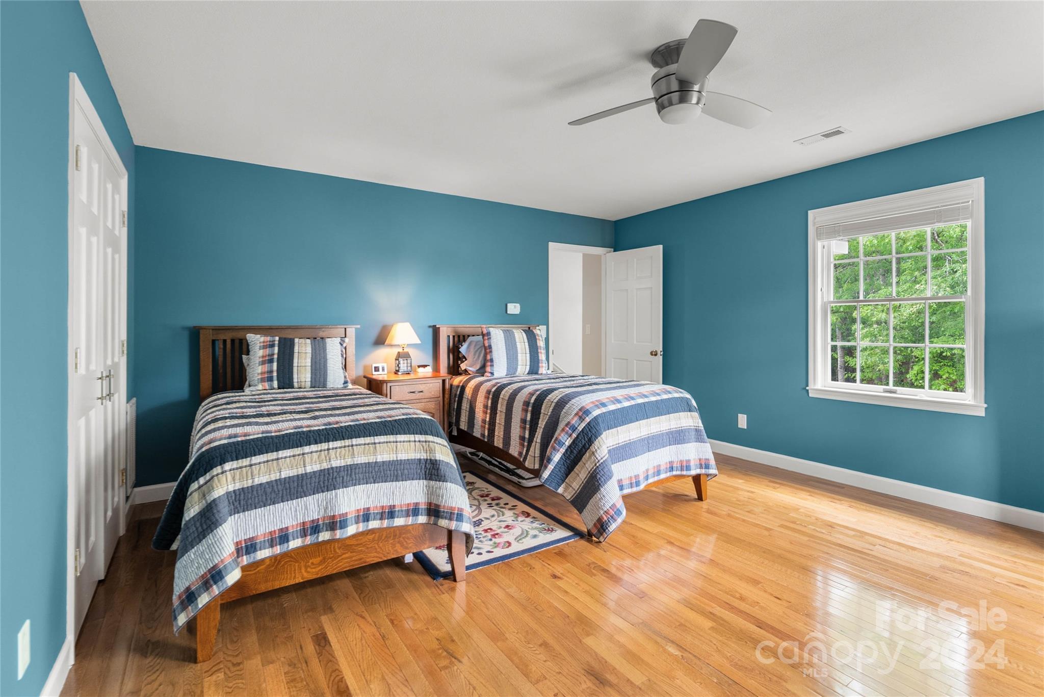 1154 Landrum Road Columbus, NC 28722 - Photo 23 of 36 a bedroom with a bed and a chandelier