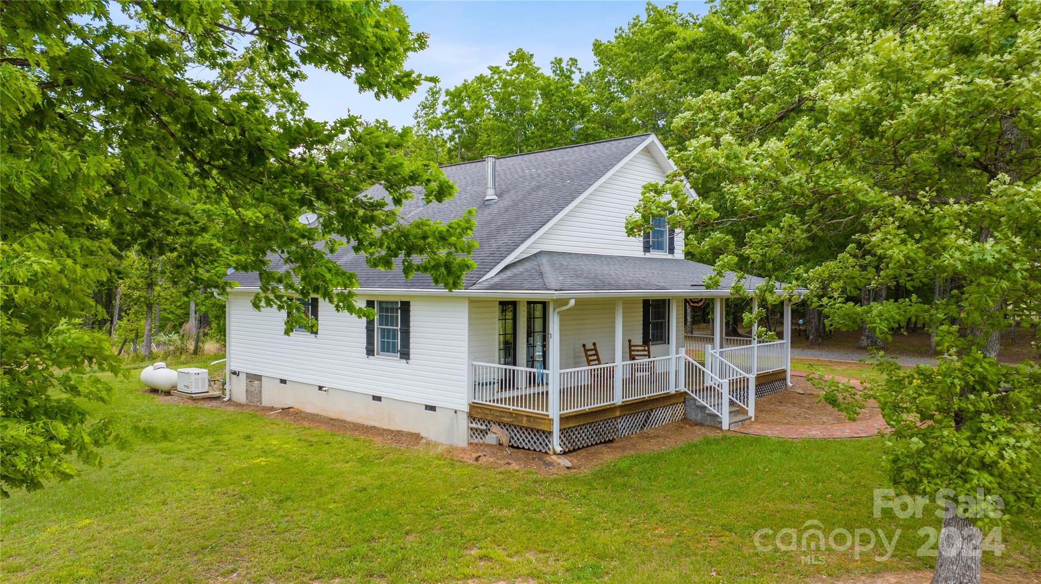 1154 Landrum Road Columbus, NC 28722 - Photo 25 of 36 a view of a house with a yard and a large tree