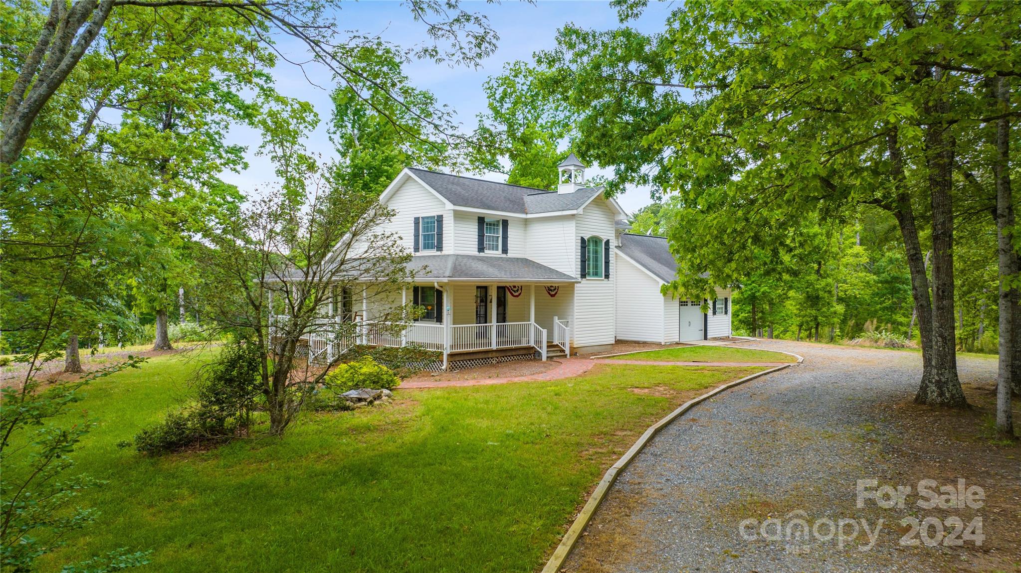 1154 Landrum Road Columbus, NC 28722 - Photo 5 of 36 a view of a house with a big yard potted plants and large tree