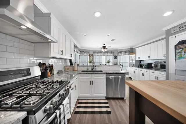 a kitchen with a stove sink and cabinets