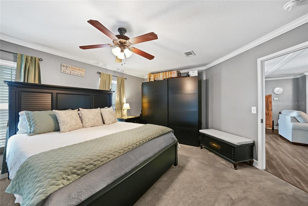 14 North Cardinal, Unit B14 Punta Gorda, FL 33950 - Photo 20 of 40 a spacious bedroom with a bed and ceiling fan