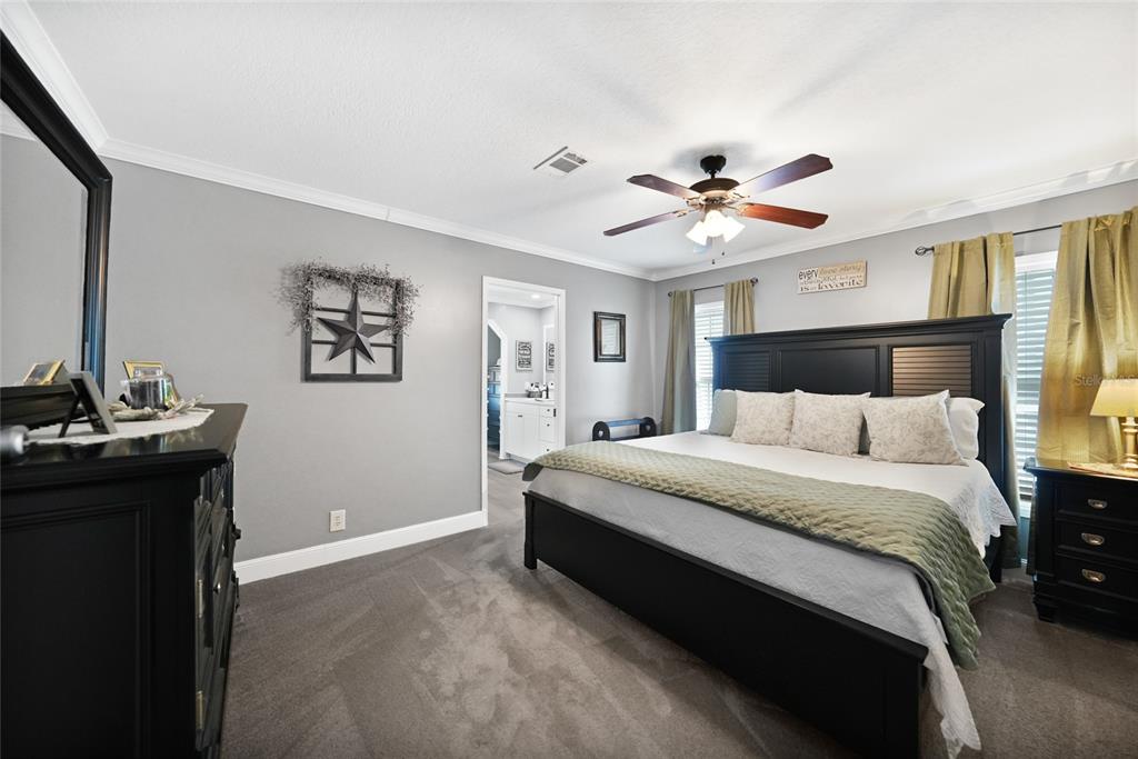 14 North Cardinal, Unit B14 Punta Gorda, FL 33950 - Photo 21 of 40 a spacious bedroom with a bed and a chandelier