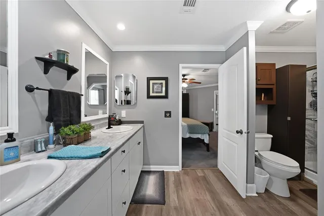 a bathroom with a granite countertop sink a toilet and shower