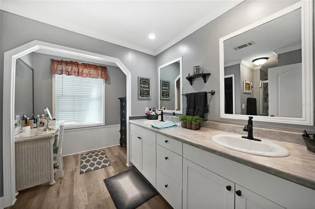 a bathroom with a sink double vanity and a mirror