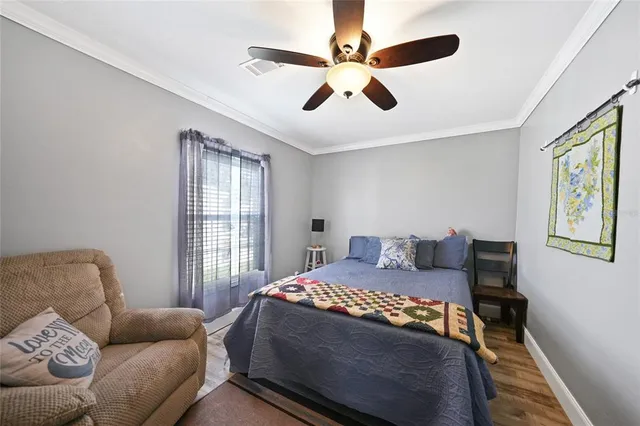 a bedroom with a bed couch and window