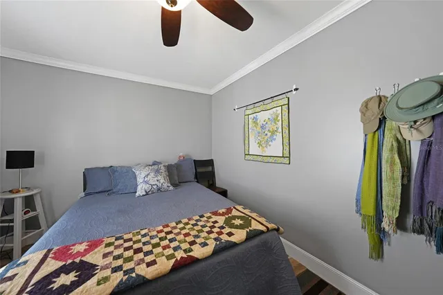 a bedroom with a bed and painting on the wall