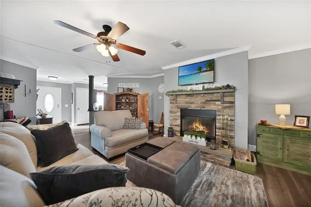 a living room with furniture a fireplace and a flat screen tv