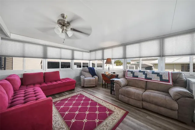 a living room with furniture and a view of kitchen