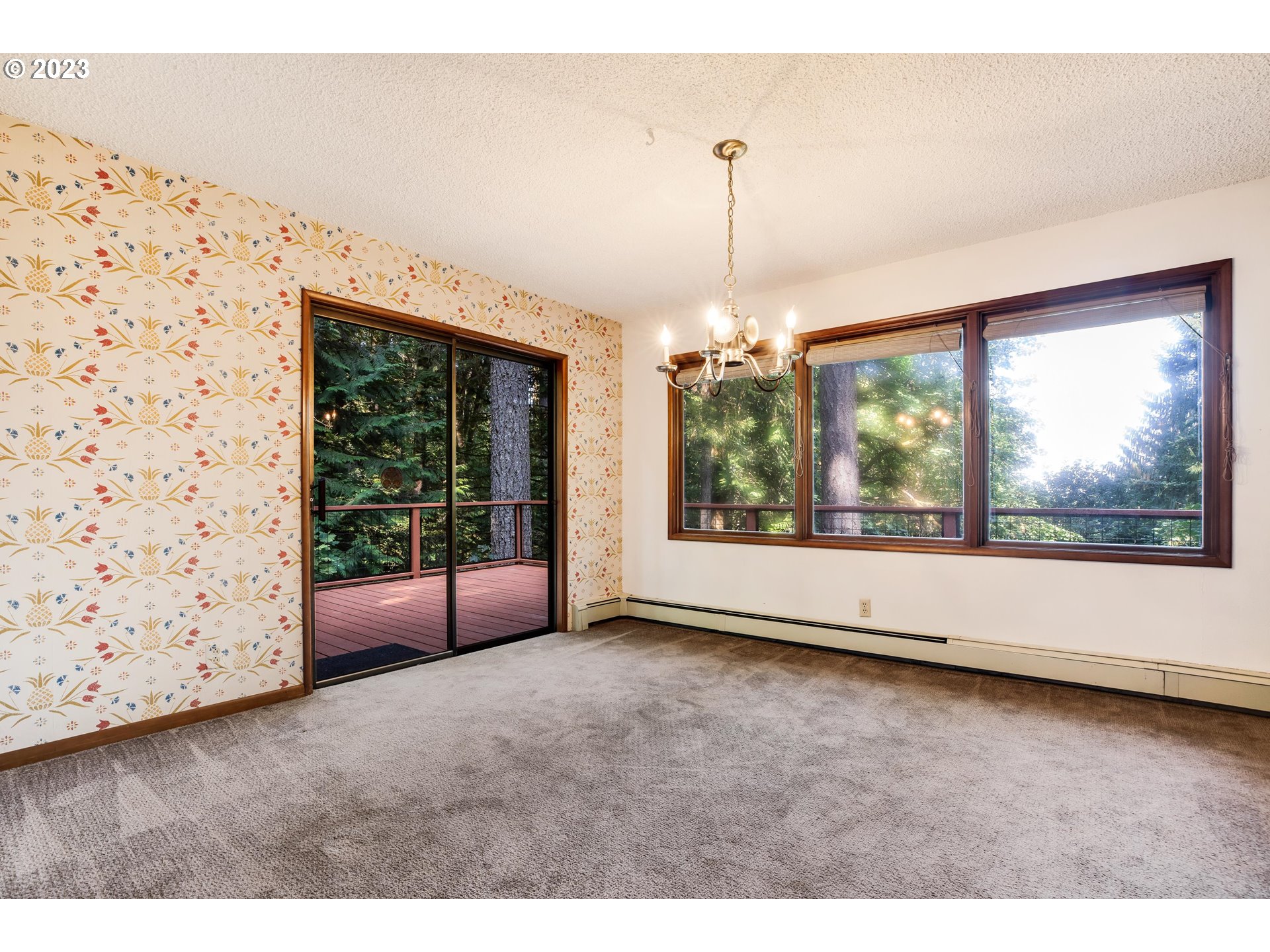 15729 Northwest Sheltered Nook Road Portland, OR 97231 - Photo 21 of 44 a view of an empty room with wooden floor and a window