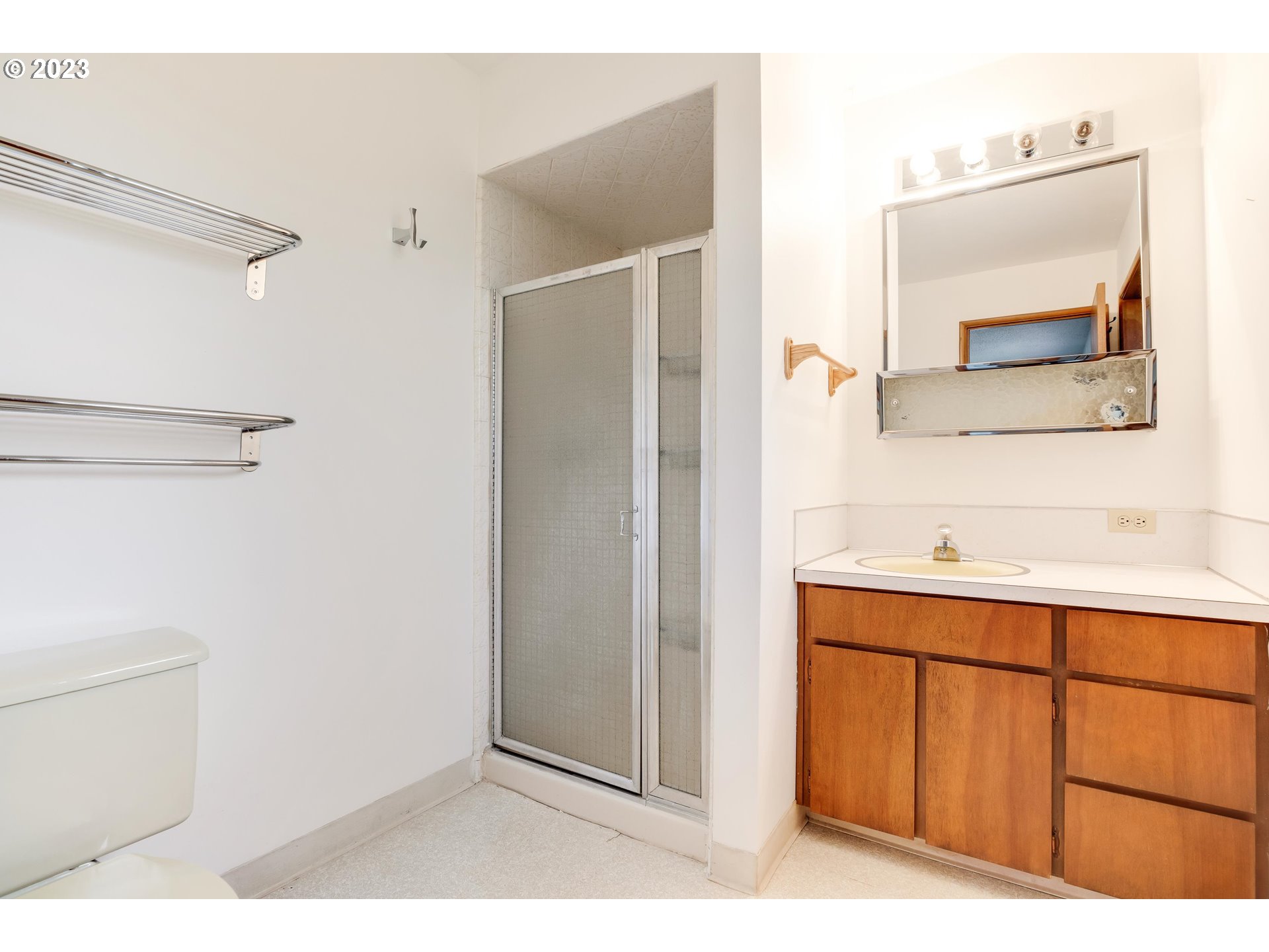 15729 Northwest Sheltered Nook Road Portland, OR 97231 - Photo 29 of 44 a bathroom with a sink vanity and mirror