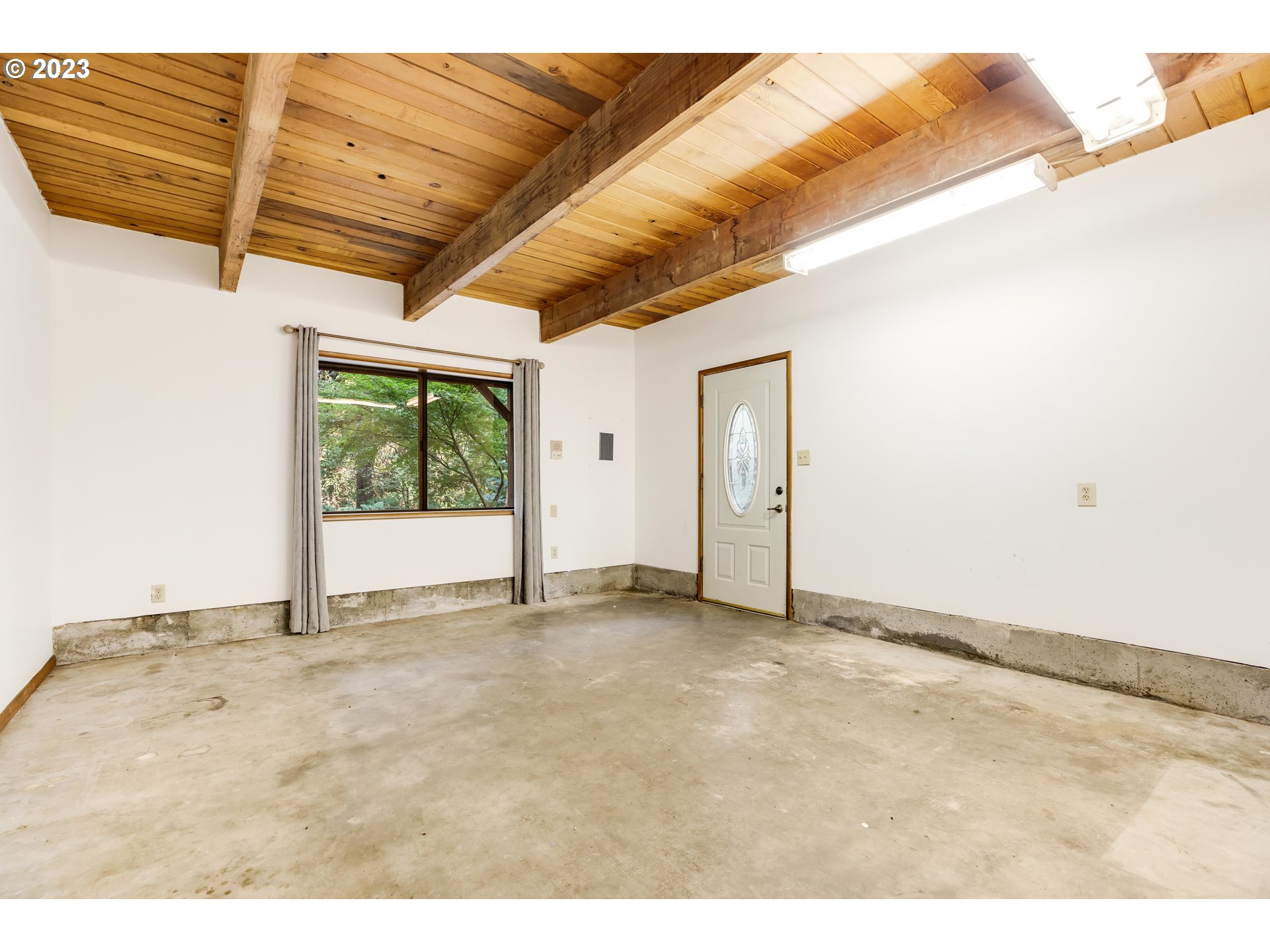 15729 Northwest Sheltered Nook Road Portland, OR 97231 - Photo 36 of 44 a view of an empty room with a window