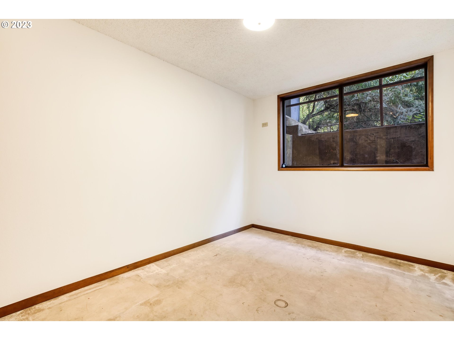 15729 Northwest Sheltered Nook Road Portland, OR 97231 - Photo 39 of 44 a view of empty room with wooden floor