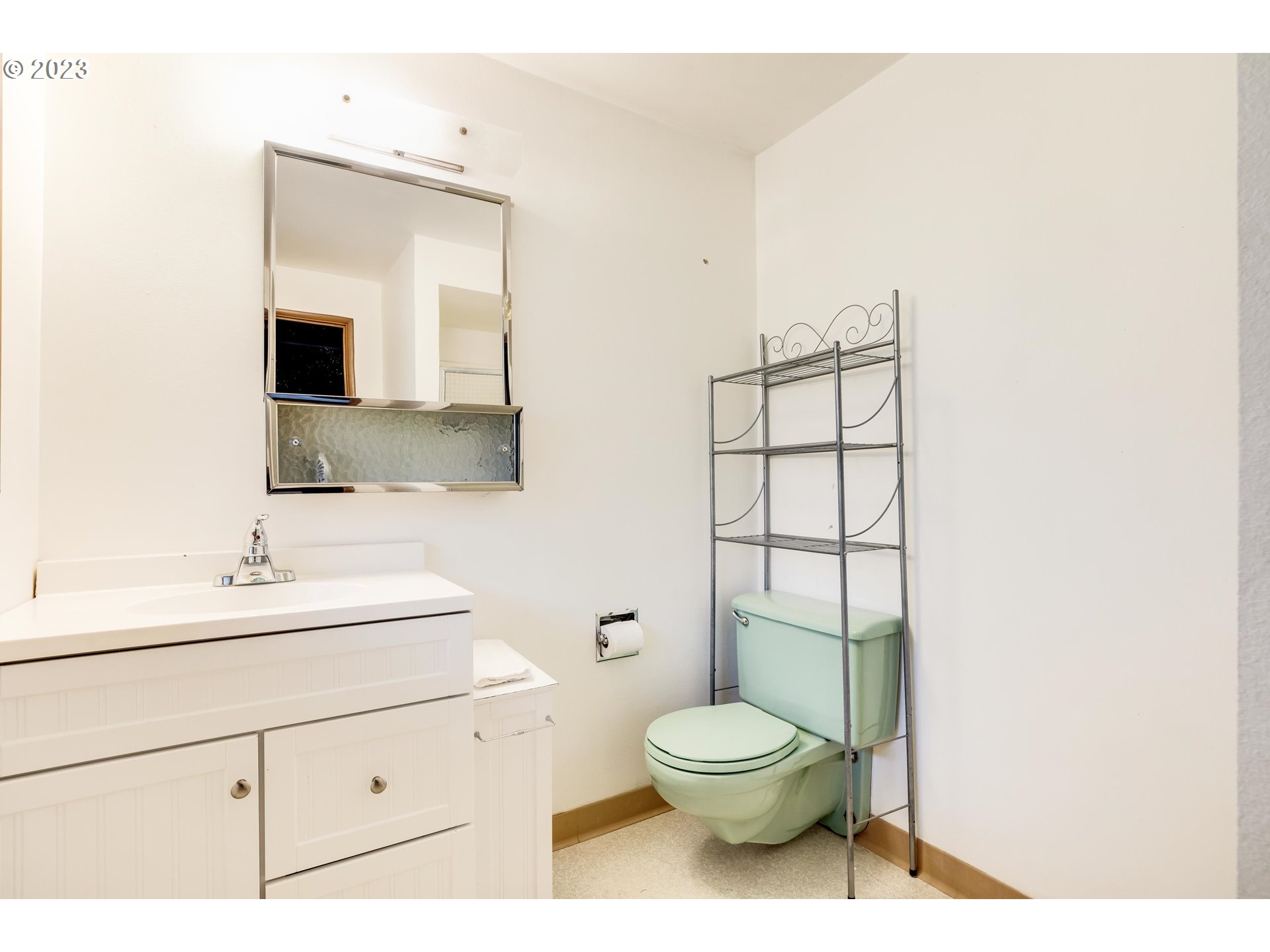 15729 Northwest Sheltered Nook Road Portland, OR 97231 - Photo 40 of 44 a bathroom with a toilet sink and mirror