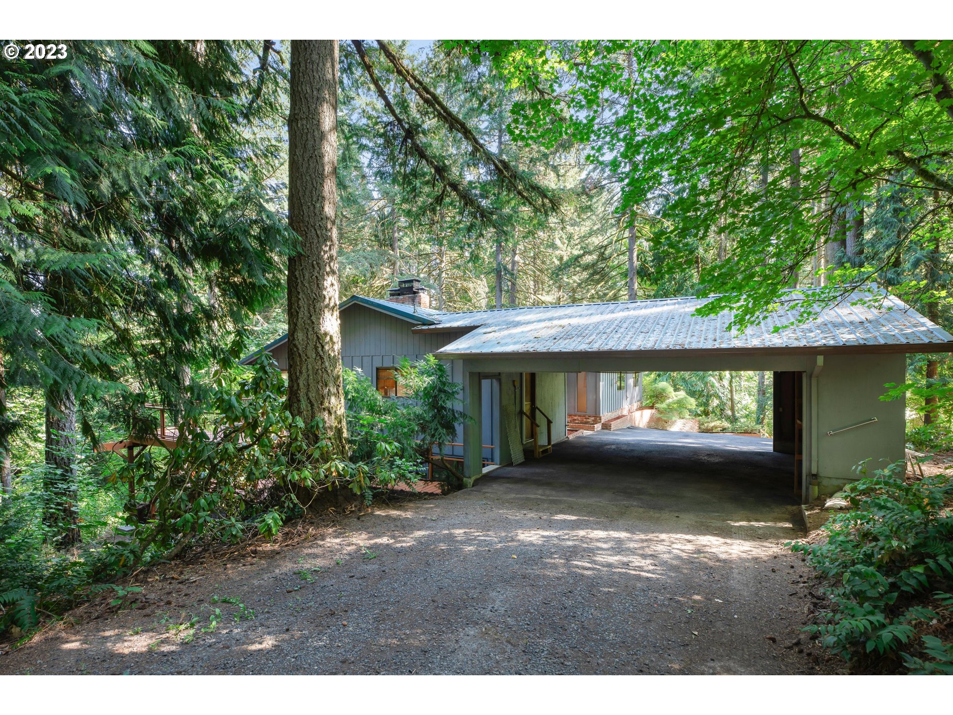 15729 Northwest Sheltered Nook Road Portland, OR 97231 - Photo 4 of 44 a view of a house with a garden