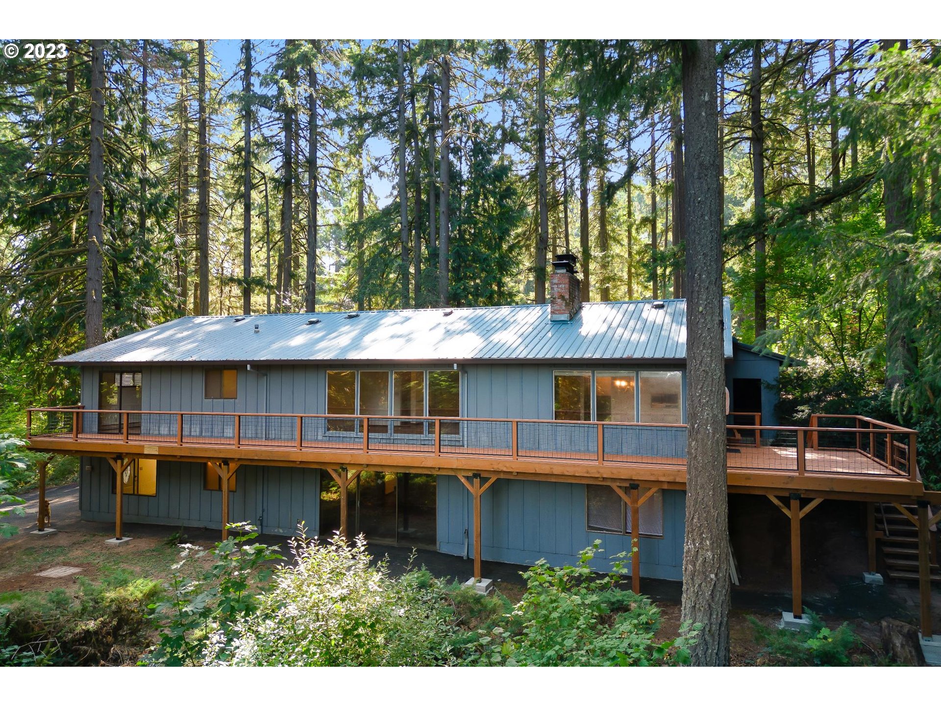 15729 Northwest Sheltered Nook Road Portland, OR 97231 - Photo 5 of 44 a view of a house with a yard and sitting area