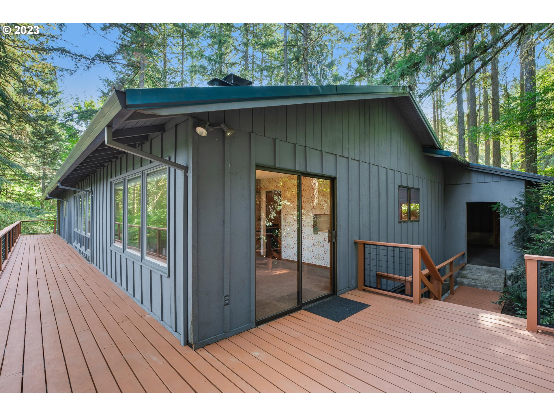 15729 Northwest Sheltered Nook Road Portland, OR 97231 - Photo 7 of 44 a view of backyard with a deck and wooden floor