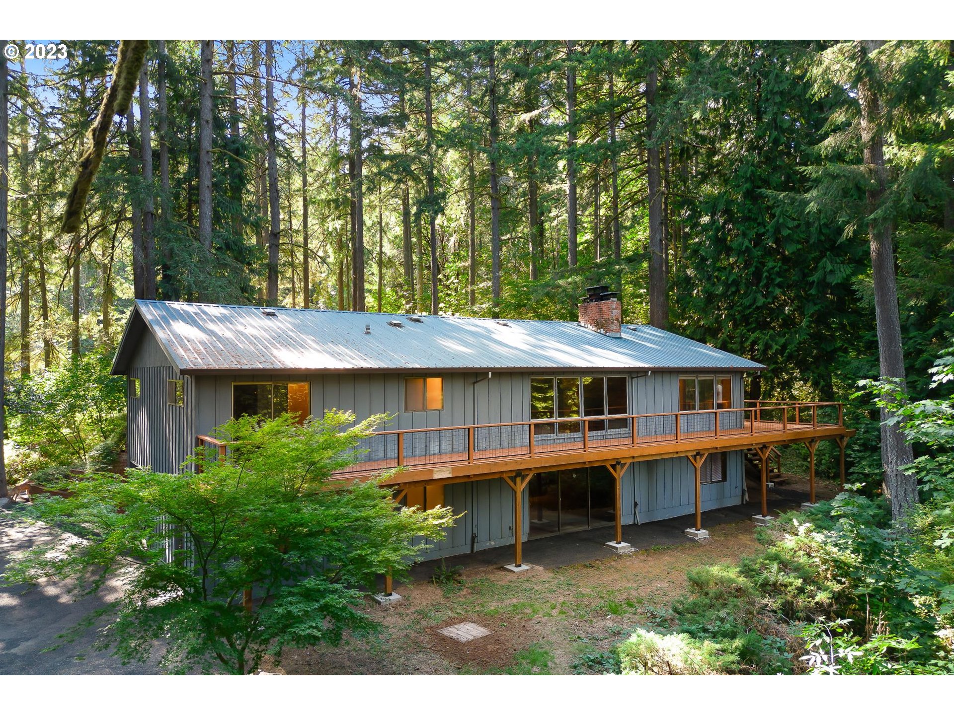 15729 Northwest Sheltered Nook Road Portland, OR 97231 - Photo 9 of 44 a view of a house with a backyard