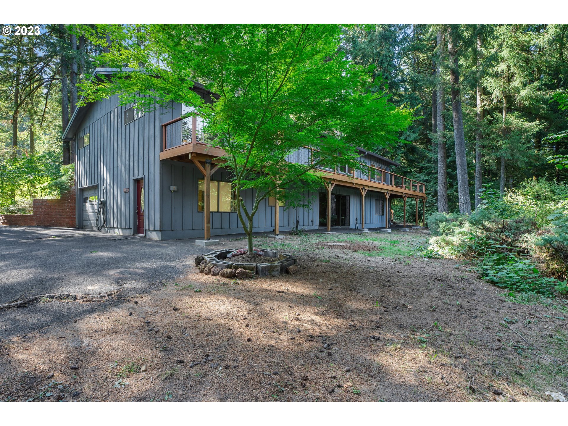 15729 Northwest Sheltered Nook Road Portland, OR 97231 - Photo 10 of 44 a backyard of a house with table and chairs