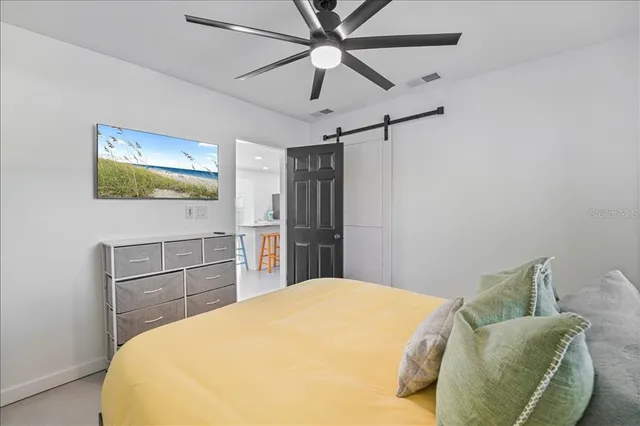 a bedroom with a bed and a chandelier