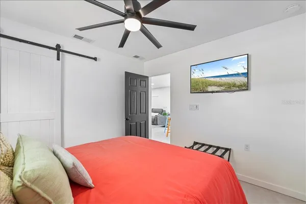 a bedroom with a bed and a painting on the wall