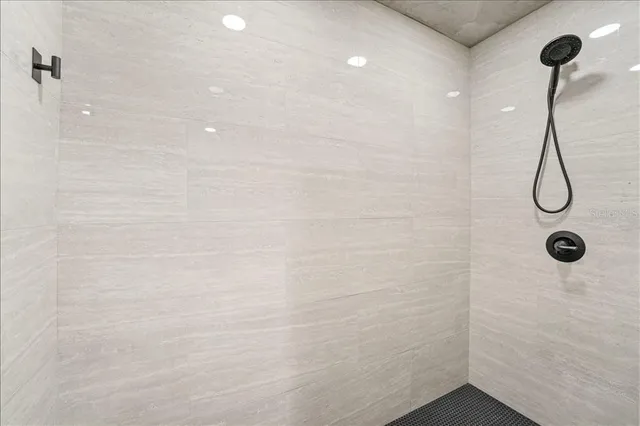 a bathroom with a granite countertop sink vanity mirror and toilet