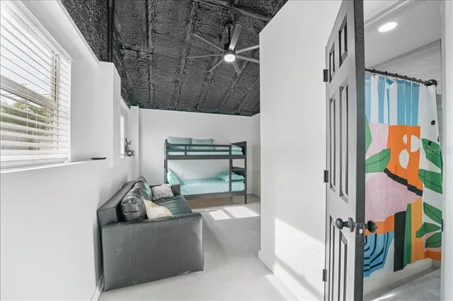 a bedroom with a bed and a painting on the wall