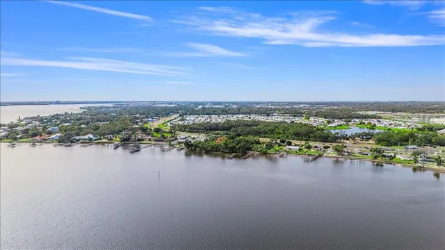 a view of a patio with table and chairs and potted plants