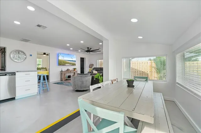 a view of a house with swimming pool and sitting area