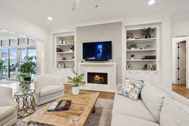 a kitchen with stainless steel appliances granite countertop a table chairs in it and white cabinets