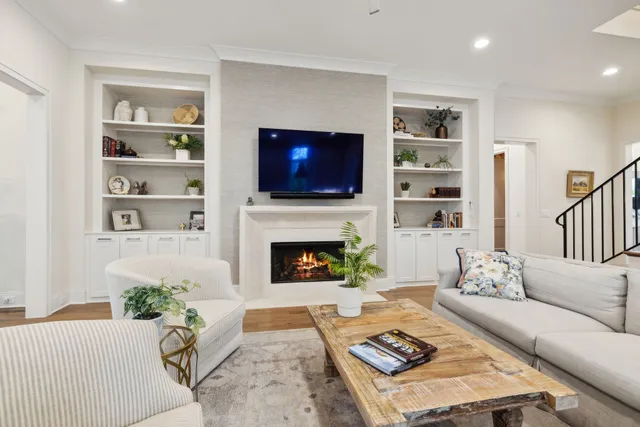 a kitchen with stainless steel appliances granite countertop a stove a sink dishwasher and a refrigerator with wooden floor