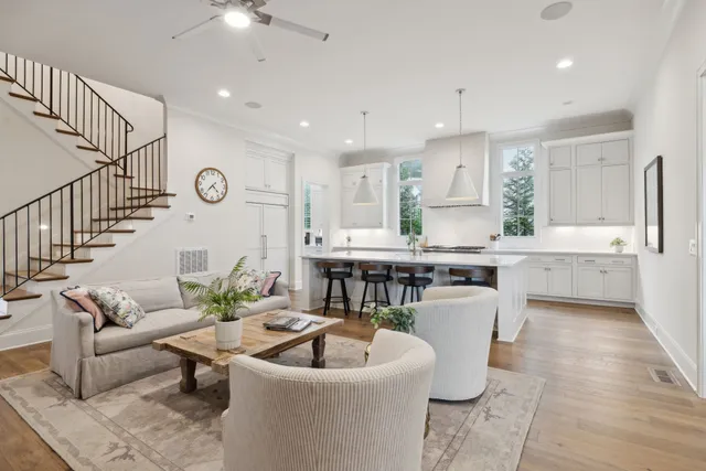 a dining room with furniture potted plants and wooden floor
