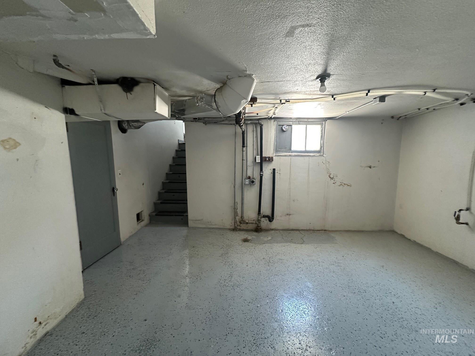 787 Southwest 3rd Street Ontario, OR 97914 - Photo 20 of 22 Below grade area featuring stairway and a textured ceiling
