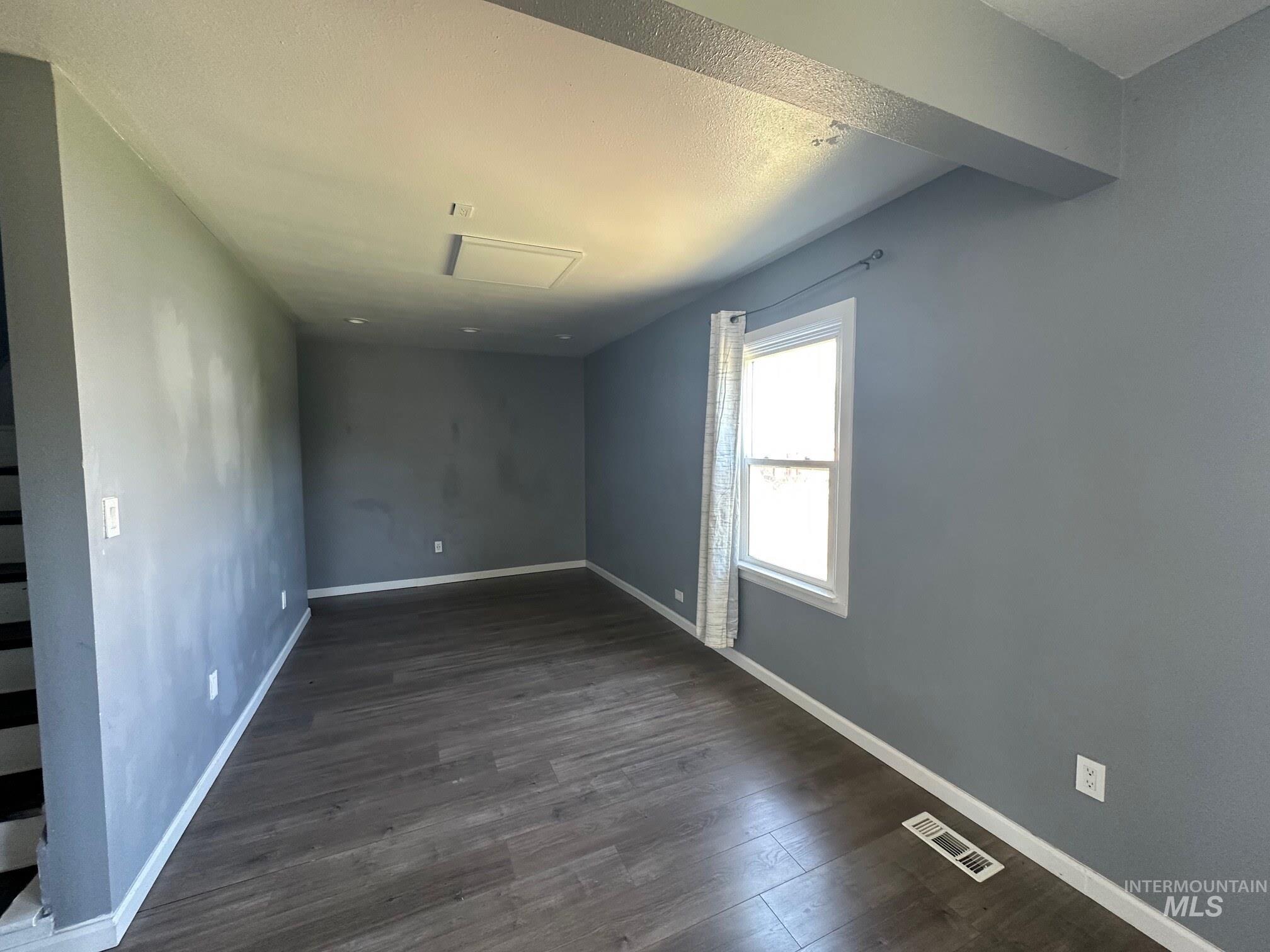 787 Southwest 3rd Street Ontario, OR 97914 - Photo 8 of 22 Spare room featuring dark wood-type flooring and baseboards