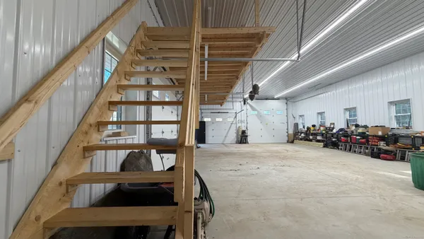 a view of a livingroom with furniture and staircase