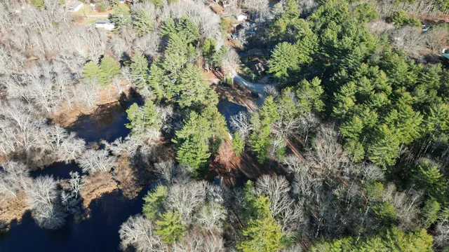 a roof deck with table and chairs under an umbrella