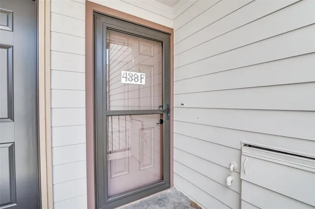 a view of a balcony with wooden floor and fence