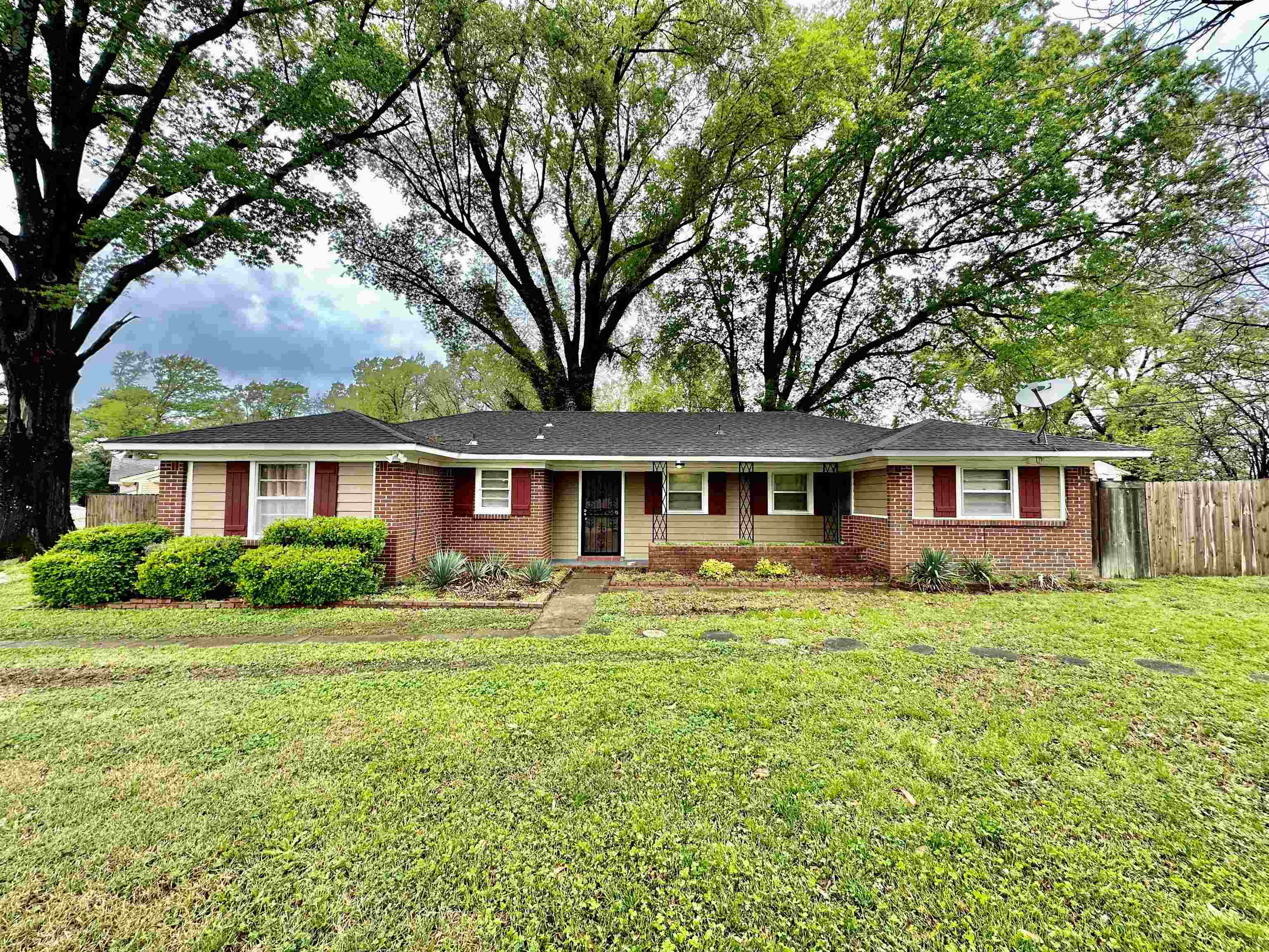 4277 Neely Road Memphis, TN 38109 - Photo 1 of 19 a front view of a house with a garden