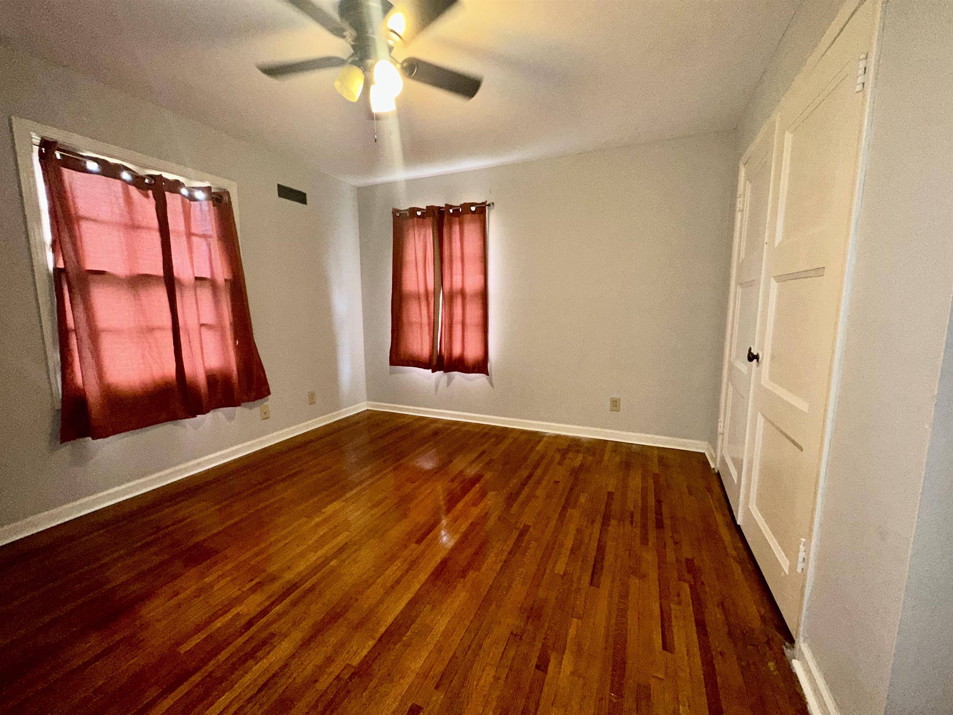 4277 Neely Road Memphis, TN 38109 - Photo 14 of 19 wooden floor in an empty room with a window