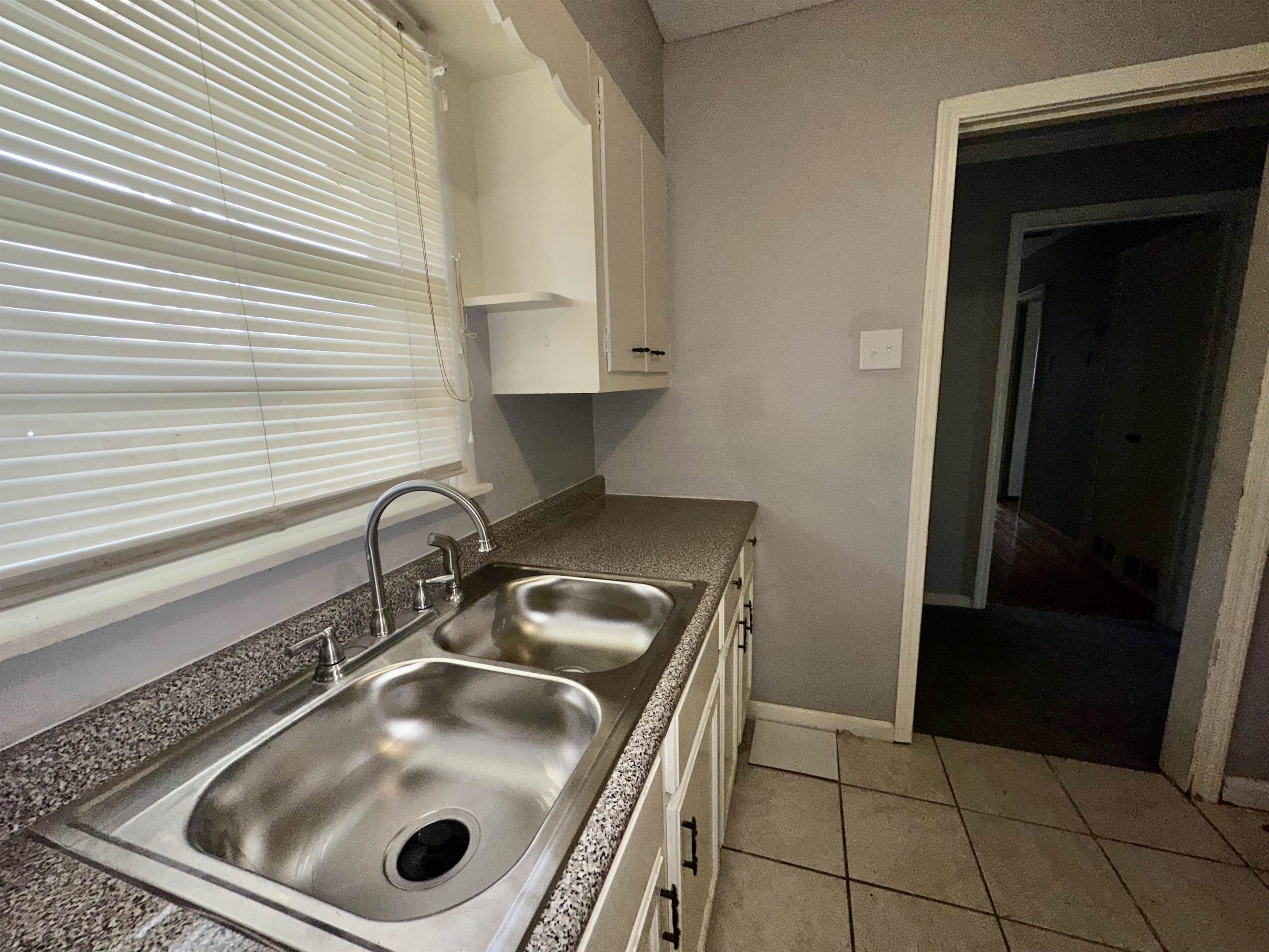 4277 Neely Road Memphis, TN 38109 - Photo 5 of 19 a kitchen with a sink and a washer dryer