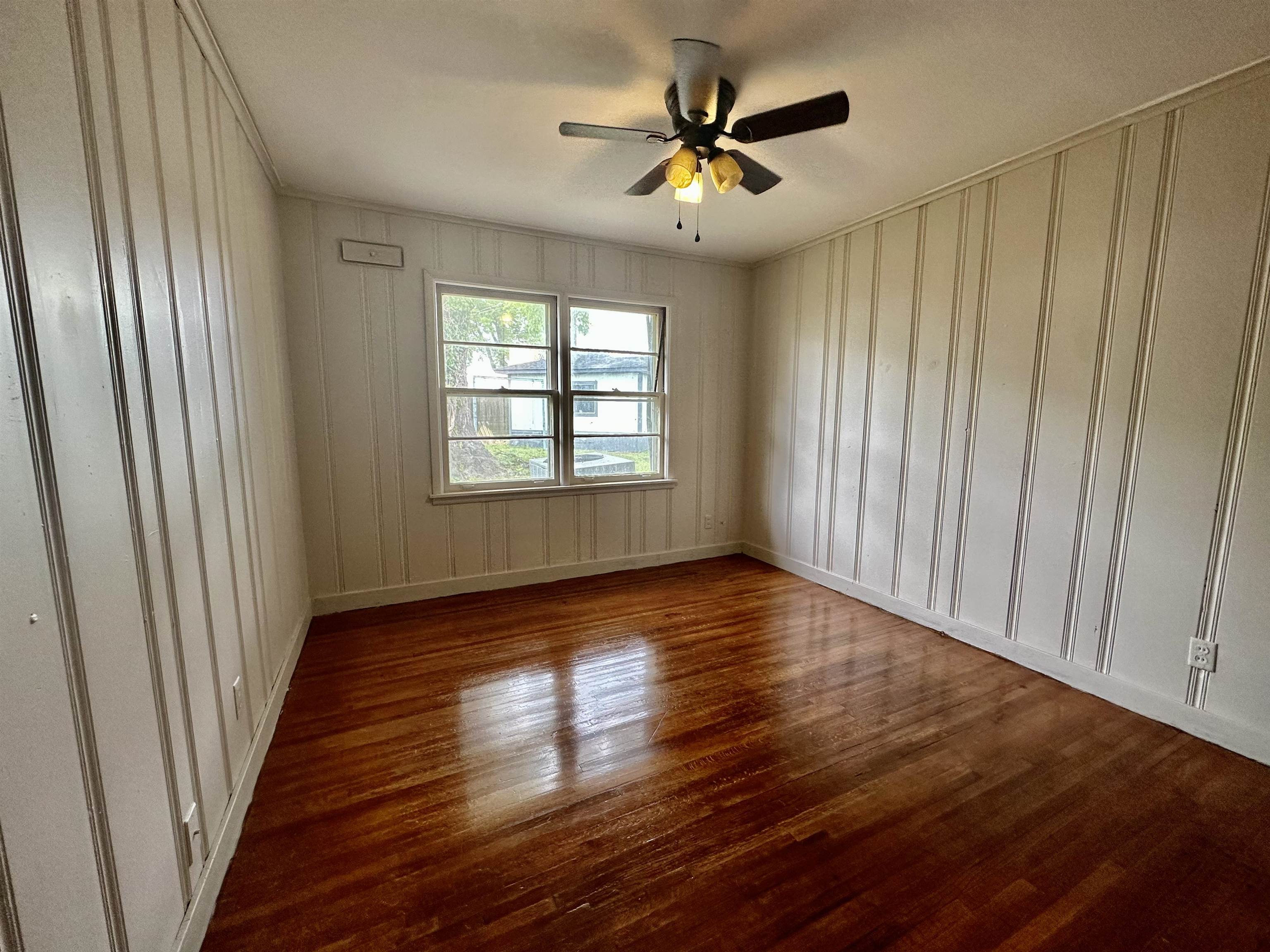 4277 Neely Road Memphis, TN 38109 - Photo 9 of 19 an empty room with wooden floor and windows