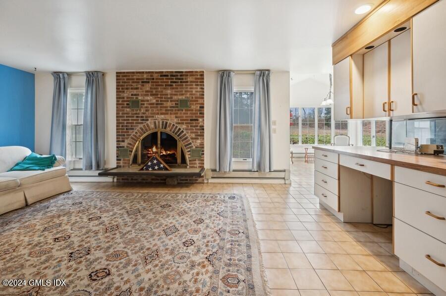 11 Roberta Lane Greenwich, CT 06830 - Photo 12 of 26 a living room with granite countertop furniture a rug and a fireplace