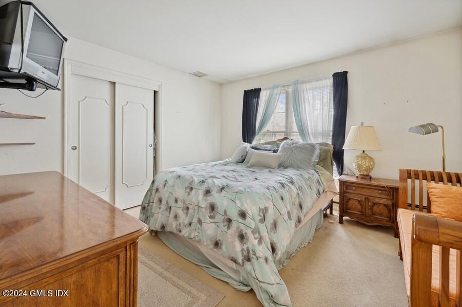 11 Roberta Lane Greenwich, CT 06830 - Photo 14 of 26 a bedroom with a bed and a flat screen tv