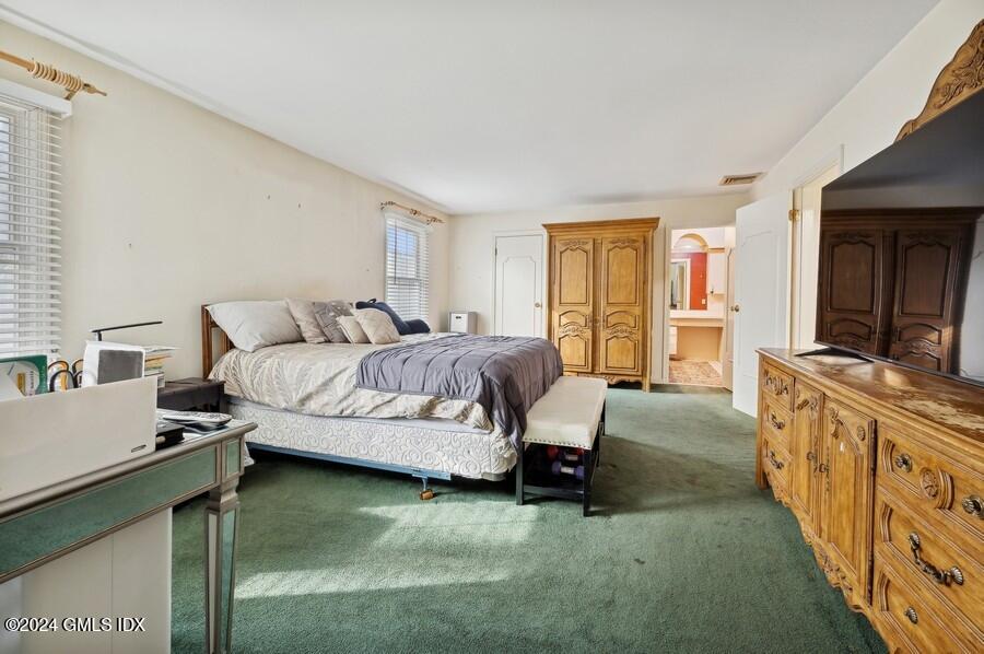 11 Roberta Lane Greenwich, CT 06830 - Photo 15 of 26 a spacious bedroom with a bed and a television