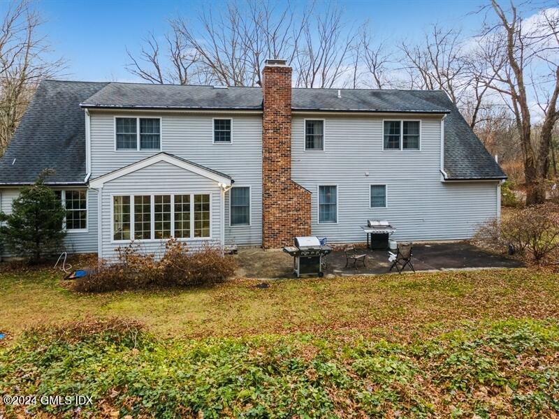 11 Roberta Lane Greenwich, CT 06830 - Photo 2 of 26 a front view of house with yard and trees in the background