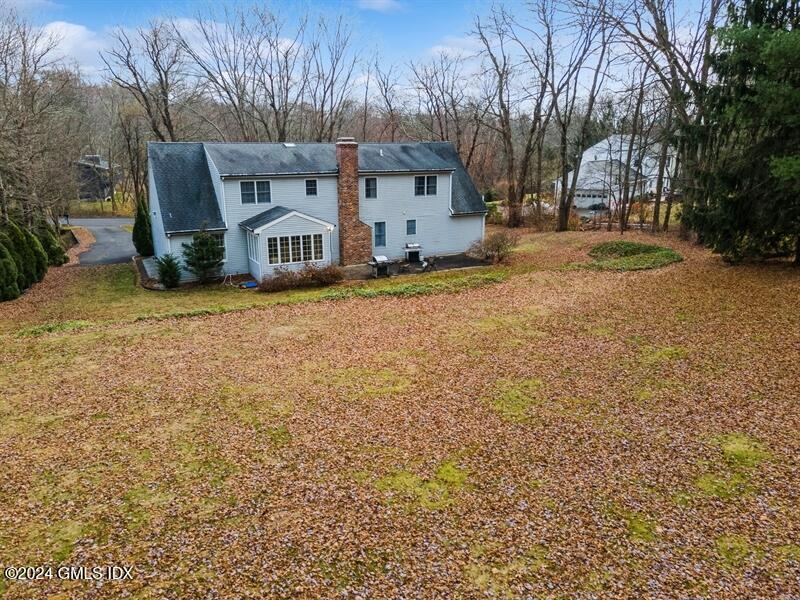 11 Roberta Lane Greenwich, CT 06830 - Photo 18 of 26 a front view of residential houses with yard and trees